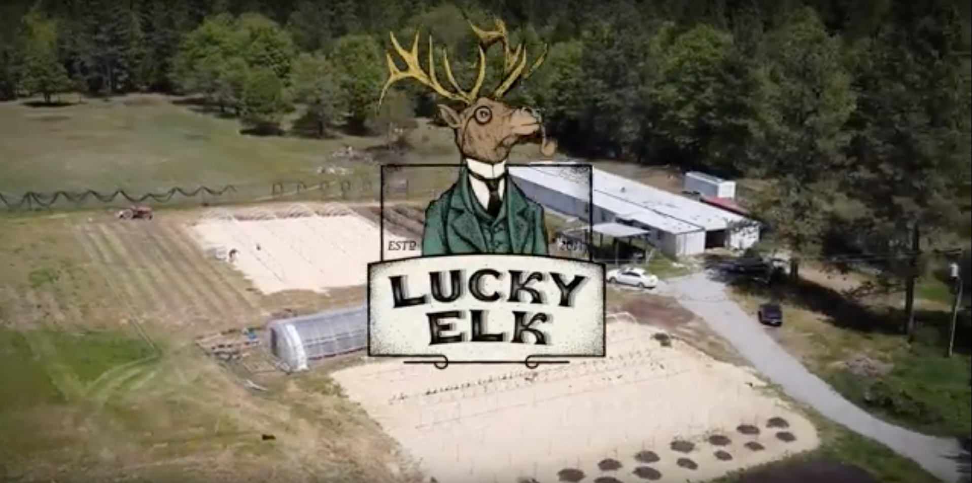Load video: Lucky Elk Logo over Farm Photo